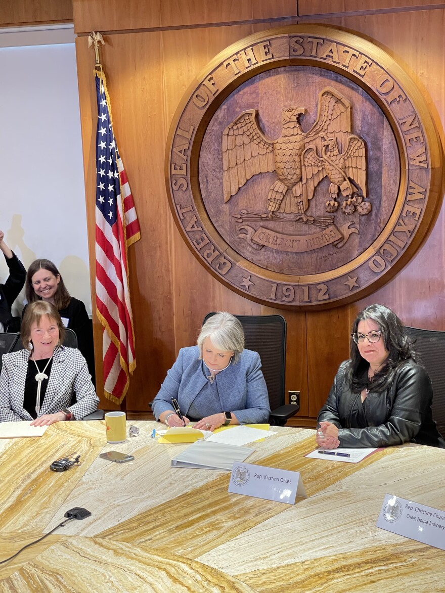 Governor Michelle Lujan Grisham signs House Bill 41 in the Roundhouse.