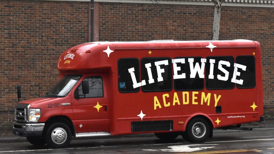 A LifeWise Academy bus drives through New Albany on February 18, 2026.