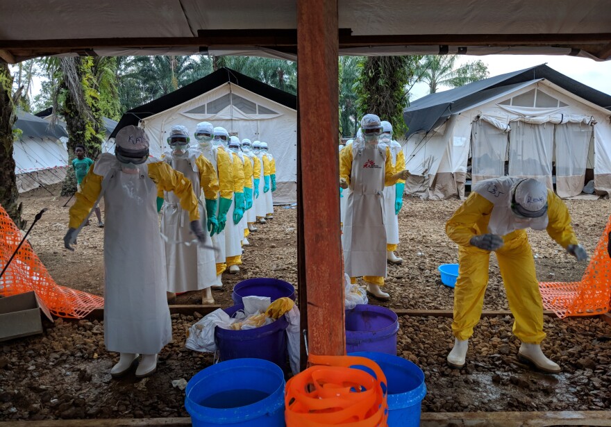 Health workers remove their protective suits at a treatment center set up by Doctors without Borders in Mangina, a town in the Democratic Republic of Congo.