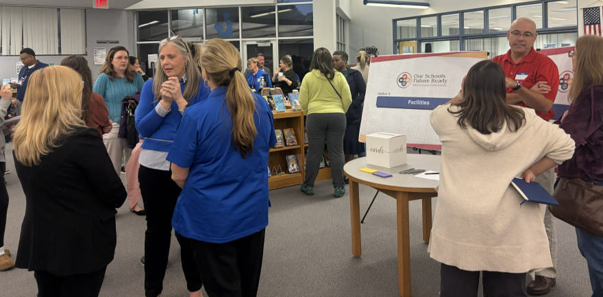 People attending the Oak View Middle School engagement session discuss questions and feedback with JBPro and Alachua County Public School representatives in the media center.