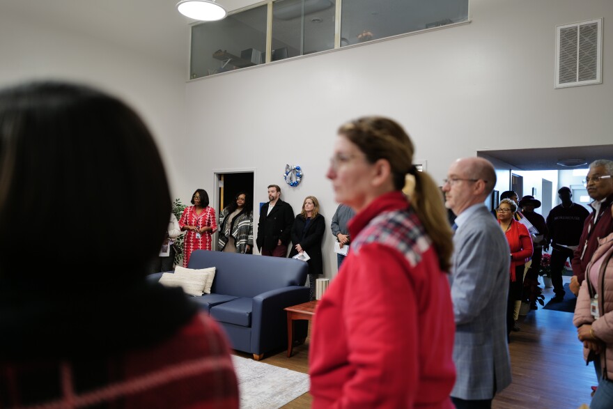 Community partners, local officials and staff gather inside the newly renovated South Eastern Family Project during a holiday open house in Newport News.