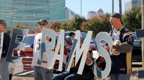 Rams fans line up with letters made by Jill Bauer of Columbia, Ill. on Sat. Nov. 14, 2015.