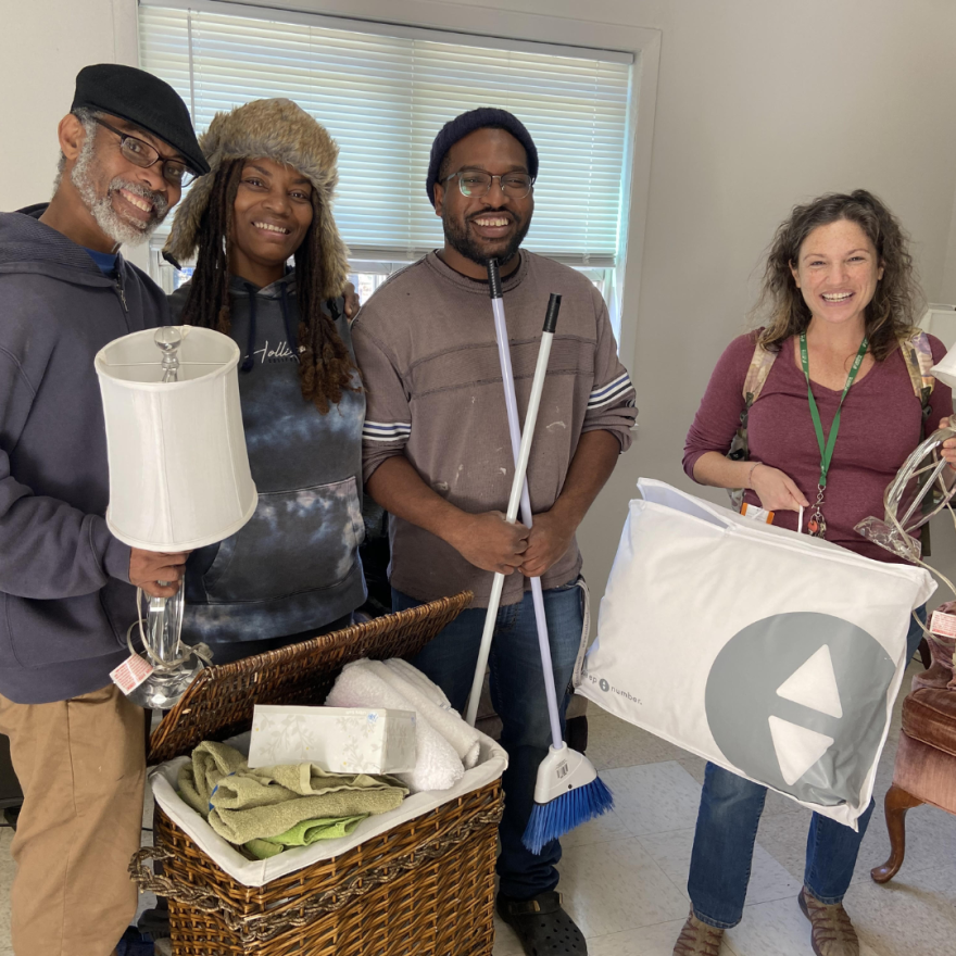 Homeward Bound clients moving into their new home, with help from a case manager.
