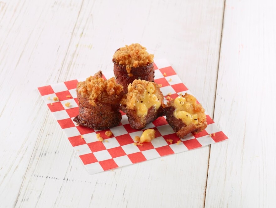 This fair food starts with Texas best smoked sausage wrapped with with hickory smoked bacon and filled with creamy mac and cheese. It's then sprinkled with a secret, sweet and spicy BBQ rub.