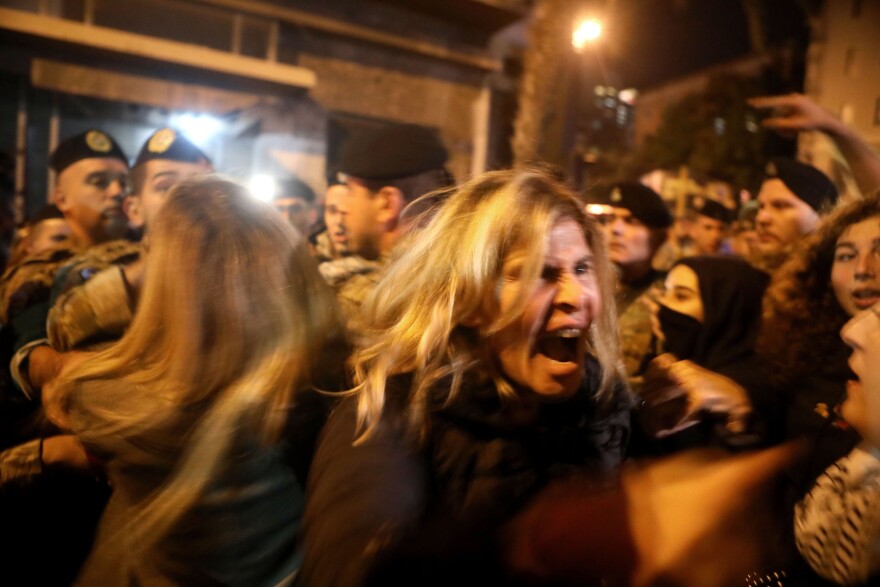 Lebanese anti-government protesters scuffle with riot police in Beirut in December 2019. The protests, which began in October, brought the country to a standstill amid a downward economic slide.