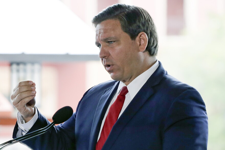 Florida Gov. Ron DeSantis speaks at a news conference at Universal Studios Wednesday, June 3, 2020, in Orlando, Fla. The Universal Studios theme park reopened today for season pass holders and will open to the general public on Friday. Bars and theme parks will be part of Florida's Phase 2 reopening after closure due to the coronavirus pandemic. (AP Photo/John Raoux)