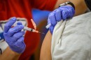 Registered Nurse Raquel Garcia, a Truman Medical Centers employee, injects James Watts, 71, with the Pfizer BioNTech COVID-19 vaccine at Linwood YMCA on Feb. 3.