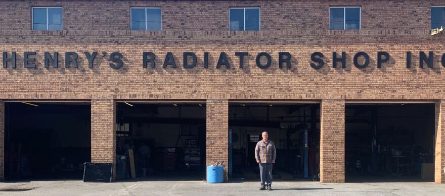 Henry Hornsby Jr. stands in front of his family business, Henry's Radiator Shop. 