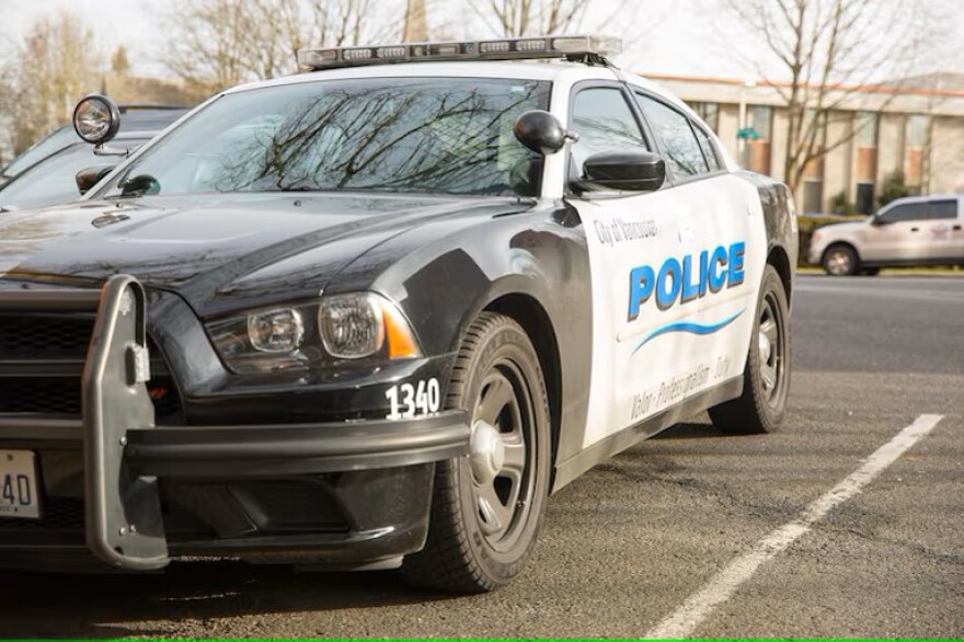 A black and white car with writing on the side of the doors that says, " City of Vancouver - Police."