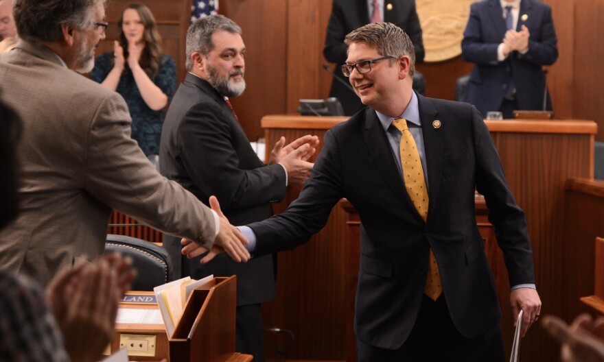 Rep. Nick Begich III, R-Alaska, shakes hands with state Rep. Ky Holland, I-Anchorage, as he leaves a joint session of the Alaska Legislature on Tuesday, March 10, 2026.