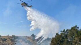 A Santa Barbara County helicopter makes a water drop Sunday afternoon on the Caballo Fire, in the Santa Ynez Valley.
