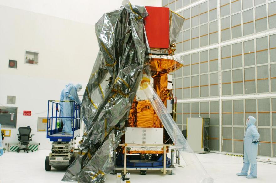 The Swift spacecraft is being unwrapped in Hangar AE at Cape Canaveral Air Force Station. Swift is a first-of-its-kind, multi-wavelength observatory dedicated to the study of gamma-ray burst (GRB) science. Its three instruments will work together to observe GRBs and afterglows in the gamma-ray, X-ray and optical wavebands. Swift is part of NASA’s medium explorer (MIDEX) program being developed by an international collaboration. During its nominal 2-year mission, Swift is expected to observe more than 200 bursts, which will represent the most comprehensive study of GRB afterglow to date. It is scheduled for launch into a low-Earth orbit on a Delta 7320 rocket on Oct. 7.