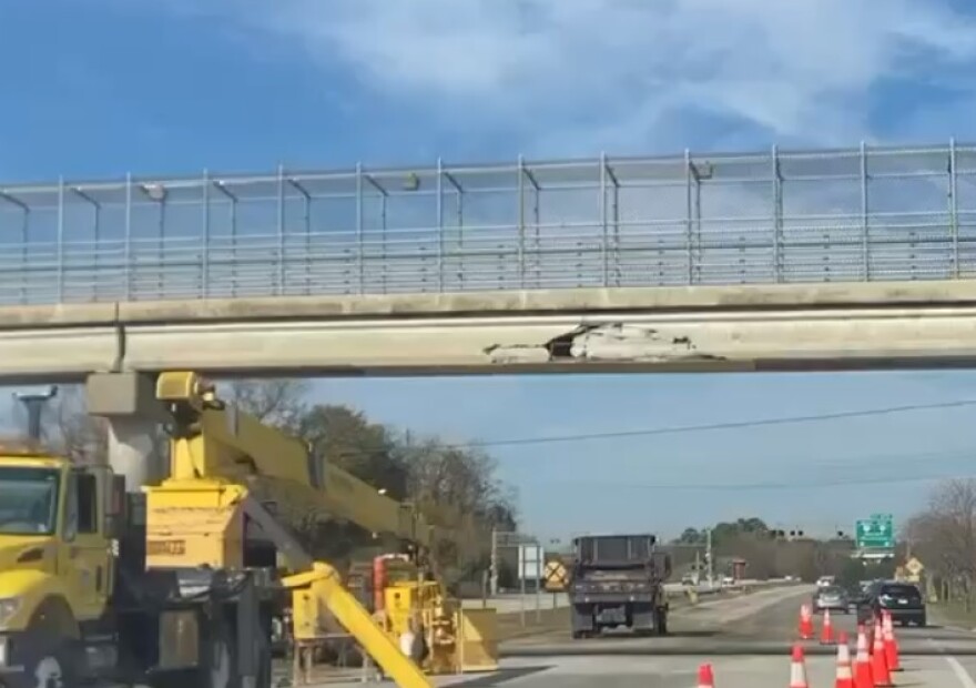 State troopers said a trash truck with its container elevated hit an overhead exit marker sign and then the Pedestrian Bridge near Elder Street in James City.