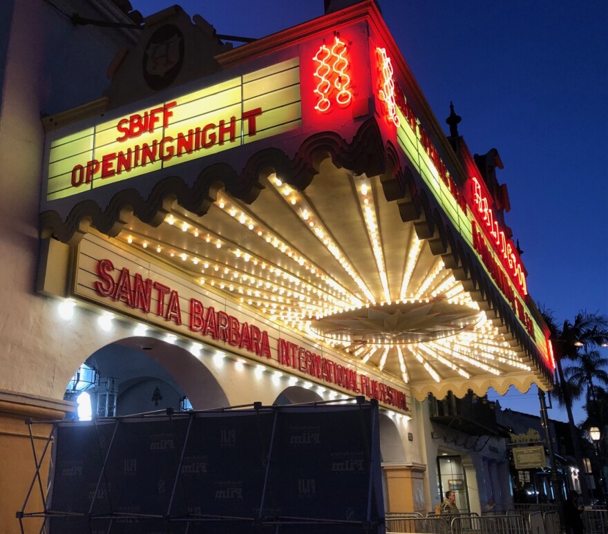 A theater marquee is lit up at dusk. Signage on the marquee reads 'Santa Barbara International Film Festival' and 'SBFF Opening Night.'