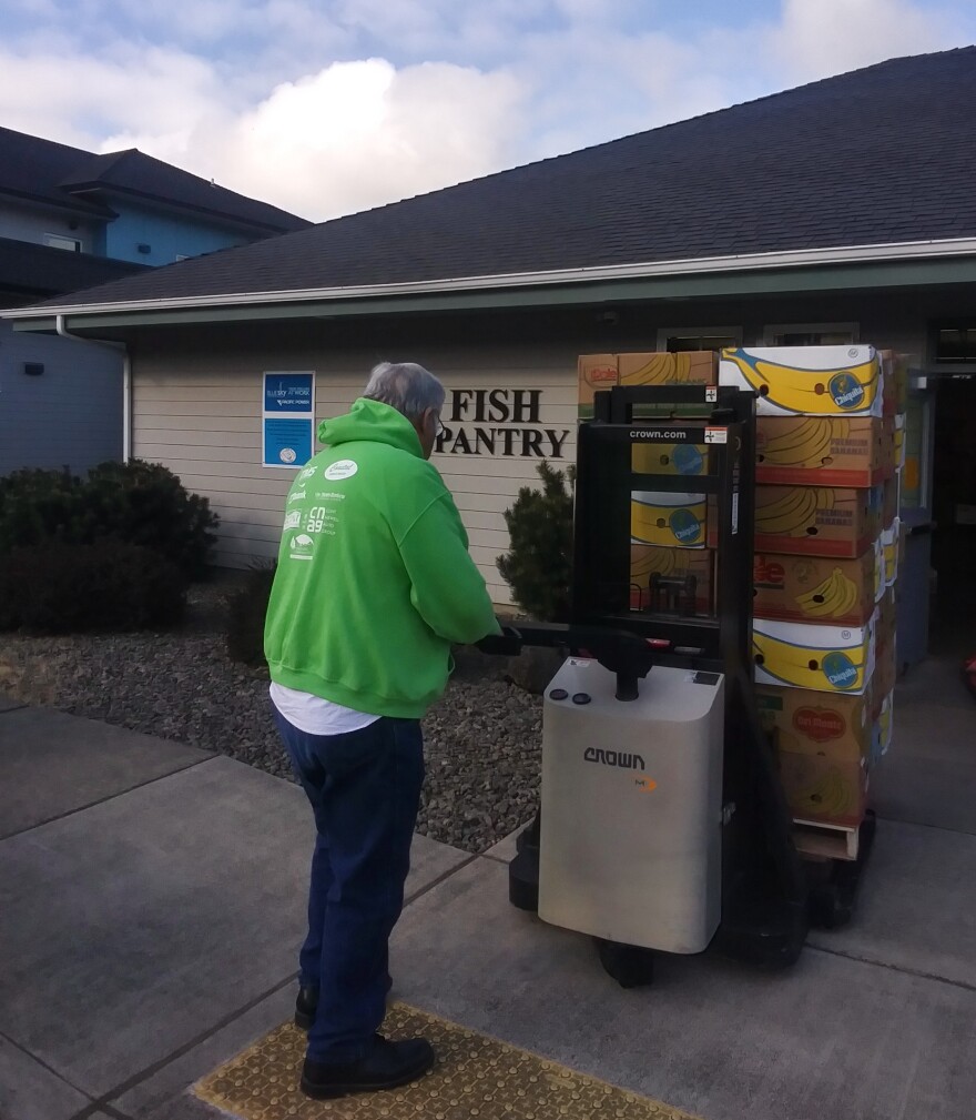 Nis Jessen, the FISH Board President, hauling food donations into warehouse