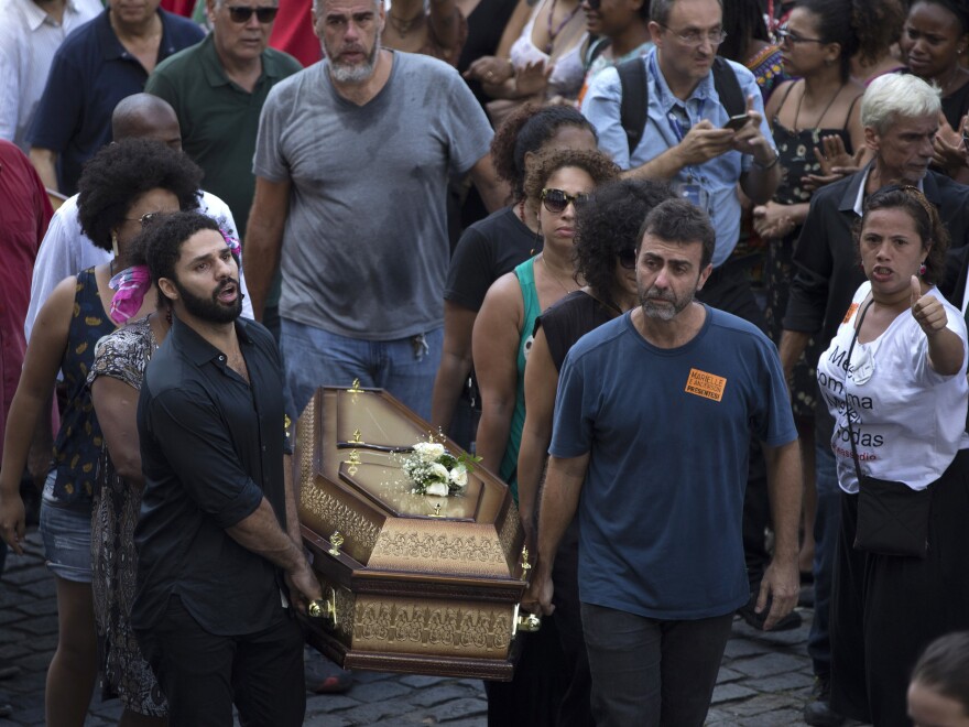 Pallbearers carry coffins containing the remains of Marielle Franco and her driver Anderson Pedro Gomes past a crowd of thousands gathered outside City Hall in Rio de Janeiro on Thursday.