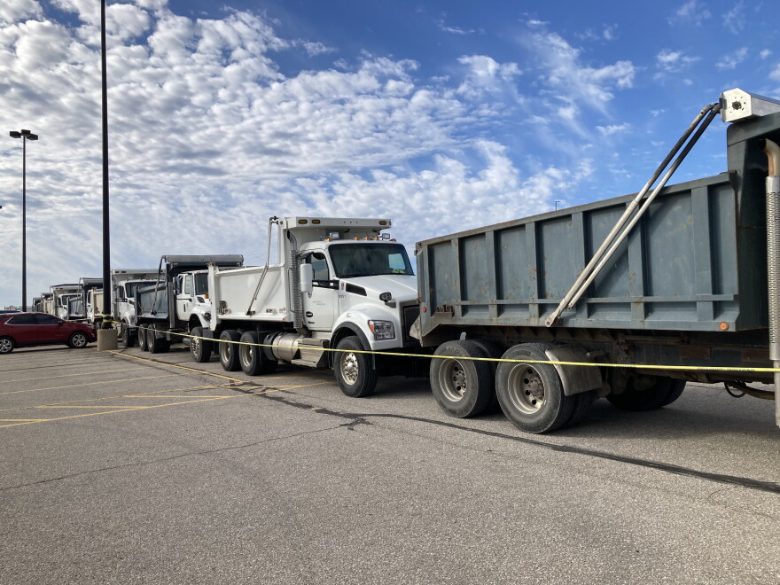 About a dozen Sedgwick County dump trucks were lined up outside Heartland Credit Union Arena on Monday morning, as well as concrete barriers in the parking lot around the arena.