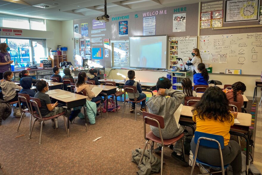 Third grade teacher Cara Cerise going over a math lesson with her students.