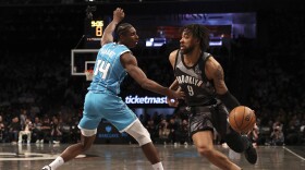 Brooklyn Nets' Trendon Watford, right, dribbles the ball against Charlotte Hornets' Moussa Diabate, left, during the first half of an NBA basketball game, Monday, Feb. 10, 2025, in New York. (AP Photo/Pamela Smith)