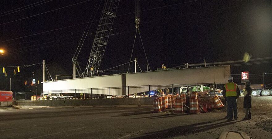 Workers lift a girder into place for the Lynx Blue Line Extension over Harris Boulevard in February 2016. 