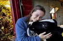 Quinci Schmidt lovingly places her head above Mandarin, one of the calves people can cuddle at Curious Cows & Company at Corcoran, Minn. on Friday Oct. 17, 2025