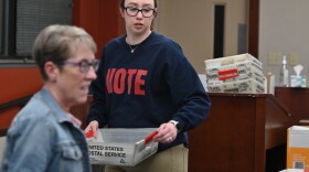 Interim Luzerne County Election Director Emily Cook carries mail-in ballots at Penn Place in Wilkes-Barre.