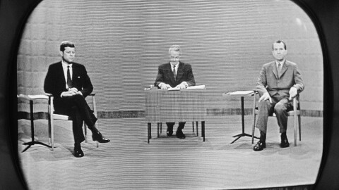 FILE - In this Sept. 26, 1960 file photo, moderator Howard K. Smith sits between, Sen. John Kennedy, left, and Vice President Richard Nixon as they appear on television studio monitor set during their debate in Chicago. (AP Photo)