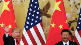 U.S. President Donald Trump waves next to Chinese President Xi Jinping in Beijing. (Andy Wong/AP)