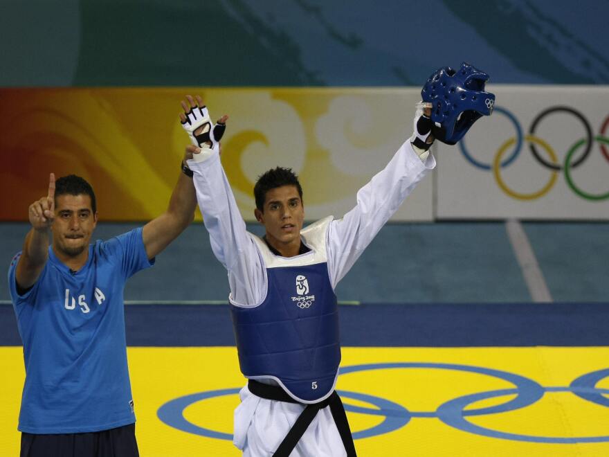 U.S. coach Jean Lopez and his brother Steven celebrate after Steven defeated Rashad Ahmadov of Azerbaijan, winning him a bronze medal in the 2008 Beijing Olympic Games.