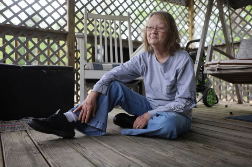 Deborah Stoner, 62, pauses for a moment on Sunday, April 2, on her porch in the Glenn Acres Manufactured Home Community of Texarkana, Texas. Stoner, who moved to Texas three years ago from West Virginia and has no health insurance, said she made the trek to be close to her children and grandchildren.