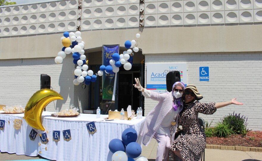 Board members Yaman Hadidi (right) and Lama Nasry (left) hand out treats, blast music, and dance to the passing cars.