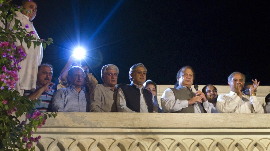 Former Prime Minister Nawaz Sharif, second from right, declares victory in Pakistan's general elections, as his brother Shahbaz Sharif, right, and others listen at the party's headquarters in Lahore.