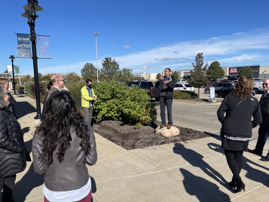 Transportation consultant Mark Fenton (center) takes a group on a walk audit of East Peoria's Levee District in October, assessing how friendly the shopping district is for pedestrians and bicyclists.