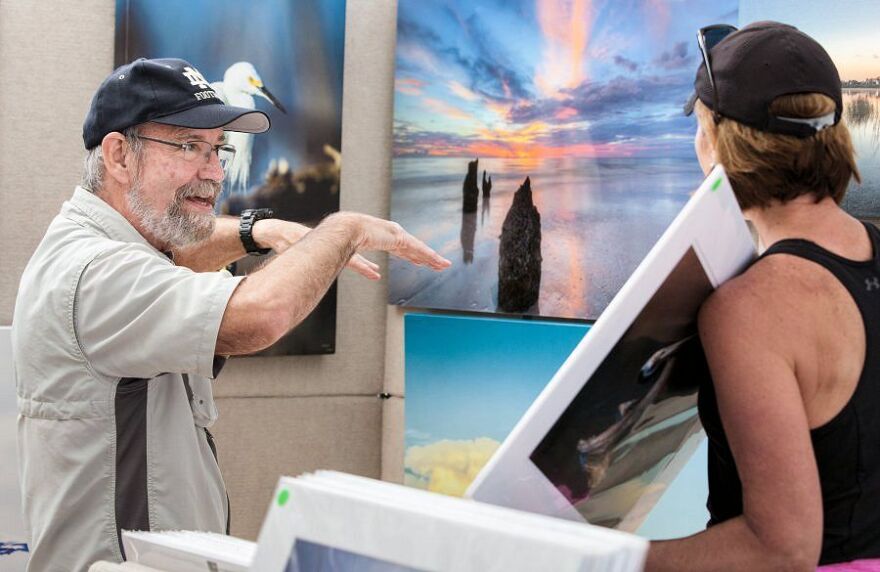 Artist and buyer discuss purchase at the Naples Artcrafters Fine Art & Crafts Show