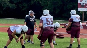 Coach Bryan Stinespring works with his players
