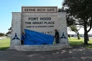 From left, Sohail Salgado, work reception technician, Fort Hood Directorate of Public Works, Operations and Maintenance Division, and Stephen Short, air-conditioning mechanic, DPW, OMD, drop a tarp at the Bernie Beck Gate sign to reveal the new name of the installation during the commemorative renaming ceremony July 28, 2025, at Fort Hood, Texas.
