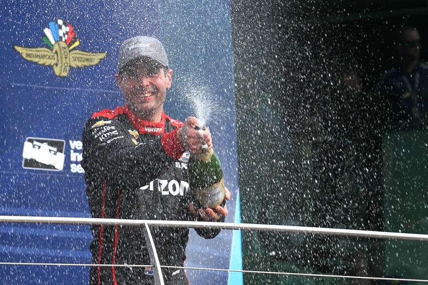 Will Power celebrates with champagne in victory lane after winning the IndyCar Grand Prix on Saturday, May 12 ,2018.