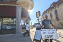 Dominic Vittone of Janesville holds a sign decrying Republican cuts to health care on the sidewalk outside the Rock County Democrats’ office in downtown Janesville from September of this year. Early voter data suggests southern Wisconsin could be a battleground area in deciding many races in the state. Midterm Election day is Tuesday, November 3.