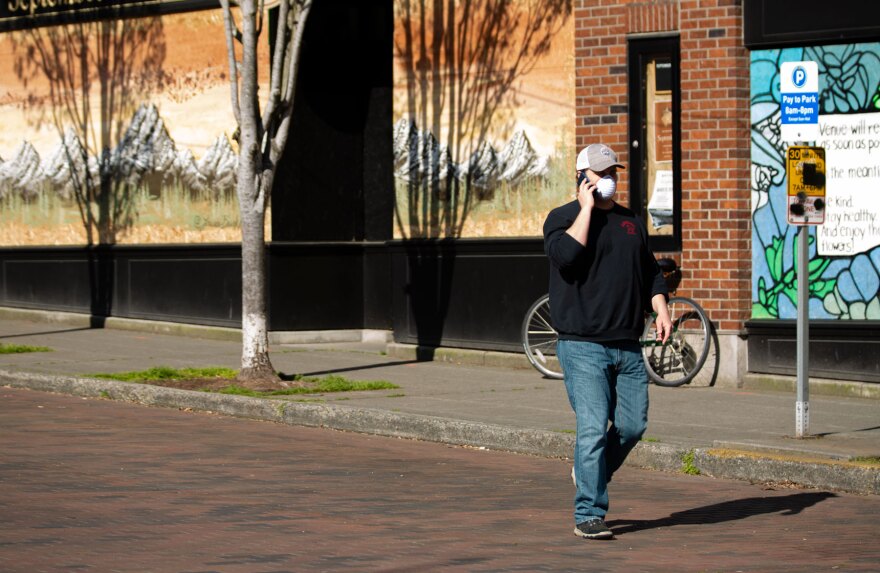 A mural covers the boarded up windows of a business in Seattle's Ballard neighborhood back in April. State officials say economic decline brought on by the pandemic could be with us long after COVID-19 ceases to be a public health emergency. 