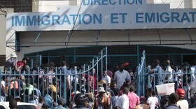 Haitians sit inside an immigration office as they wait their turns to apply for a passport, in Port-au-Prince, Haiti, Tuesday, Jan. 10, 2023. (AP Photo/Odelyn Joseph)