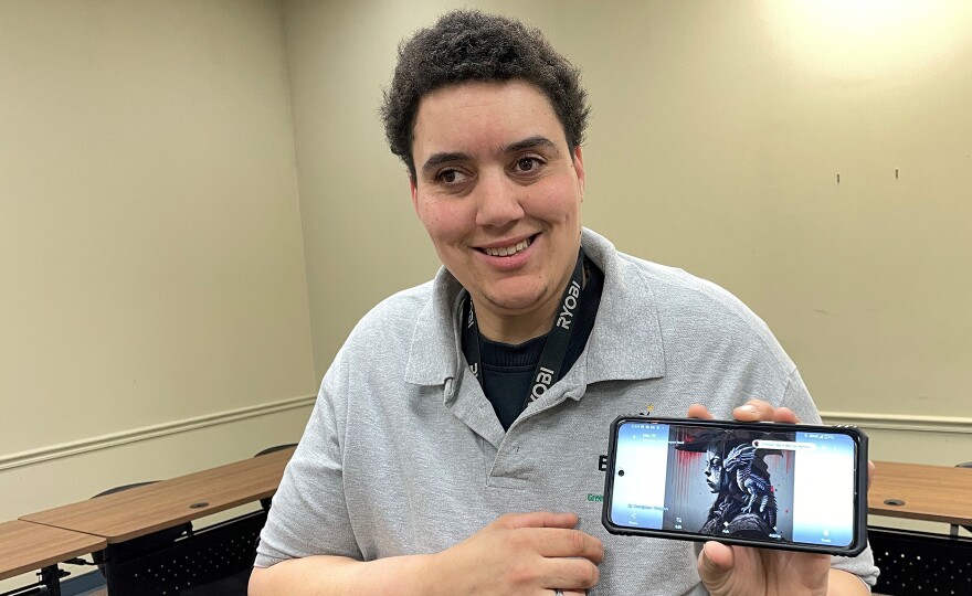 Carolynne Vaughn shows off one of her art pieces. She's taking the Greenville Literacy Association's BUILD course to learn how to connect her art and her business to people who need it most.