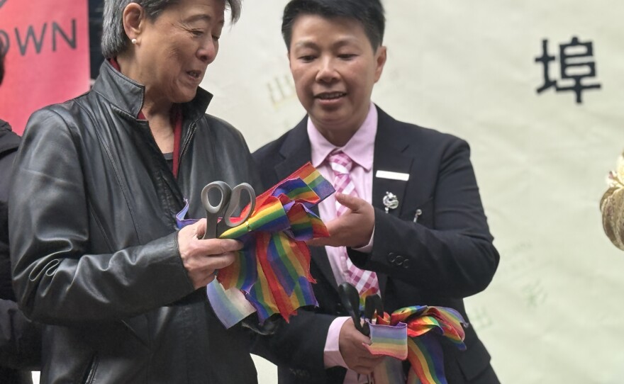 Writer Helen Zia, cutting ribbons with Xiangqi Chen.
