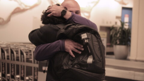 Sebastian Jimenez Peroza hugs his football coach, Ashour Peera, who advocated for his release from immigration detention facilities. (María Sofía Rodríguez/WUFT News)