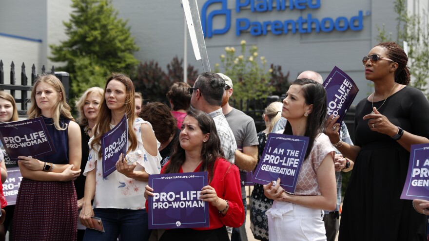Anti-abortion-rights advocates gather outside a St. Louis Planned Parenthood clinic in June. Title X recipients have been given more time to comply with new regulations.