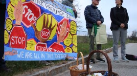 Rev. Allison Smith, right, stands with other faith leaders and volunteers at the park and ride on Marginal Way in Portland before departing for Massachusetts.