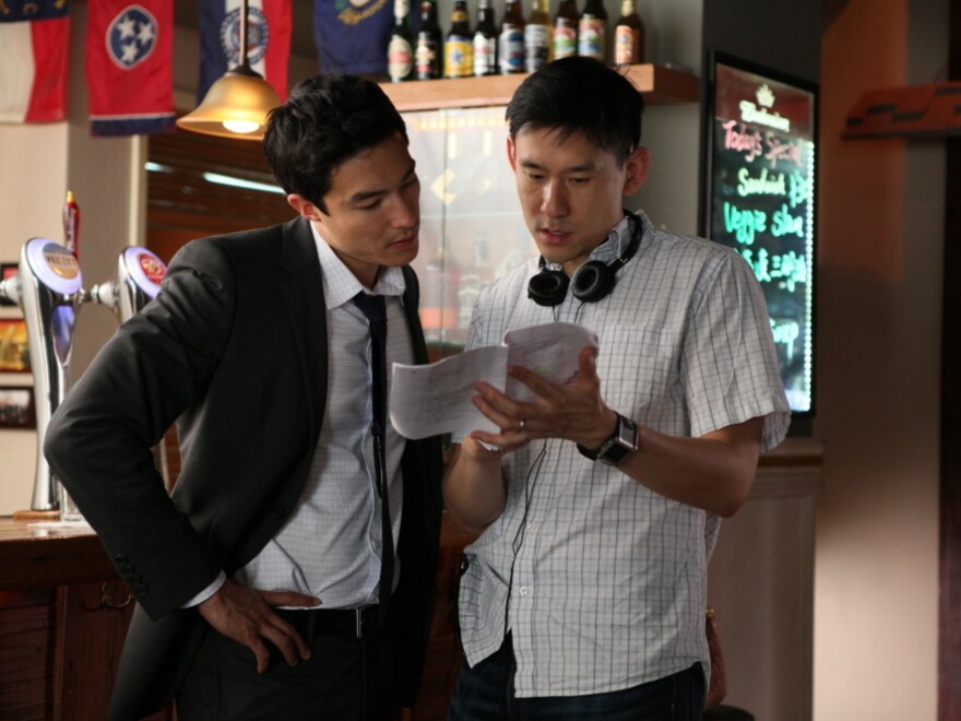 Director Daniel Hsia (right) talks with Henney on the set of <em>Shanghai Calling</em>.