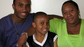Terrence, Tyrone and Sharon Flowers at their home in Brooklyn. The family is taking part in a city experiment that pays poor families for engaging in positive behaviors.