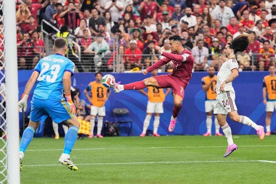 Portugal's Cristiano Ronaldo (7) shoots against Spain goalkeeper Unai Simon (23) during the World Cup round of 16 soccer match in Arlington, Texas, near Dallas, Monday, July 6, 2026.