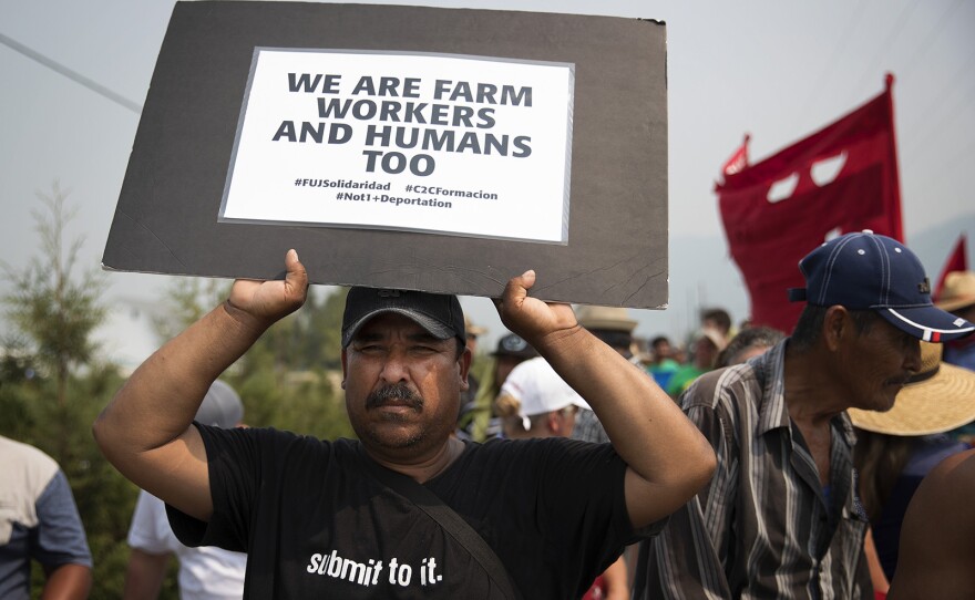 Antonio Garcia marches with other farm workers on Wednesday, August 8, 2017, on Rock Road toward Sarbanand Farms in Sumas, Washington. 