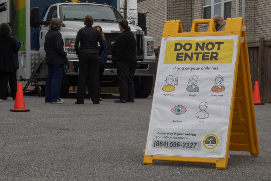 South Carolina Department of Public Health staff stand in front of an agency Mobile Health Unit in Spartanburg.